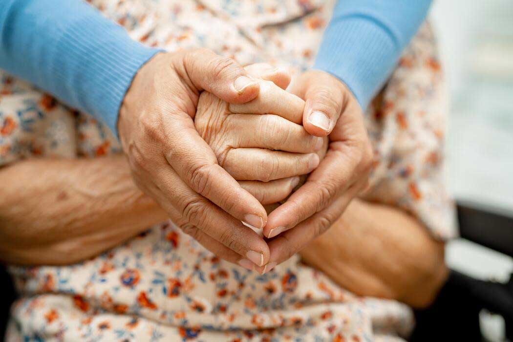 Caregiver supporting an older adult at home